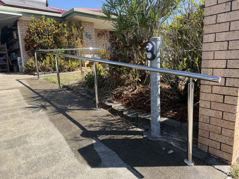 Custom stainless steel handrail along an outdoor access pathway in Brisbane